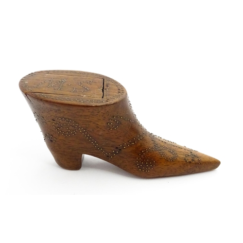 1368 - Treen : A 19thC shoe snuff box of boot form with inlaid brass studwork decoration, the sliding lid w... 