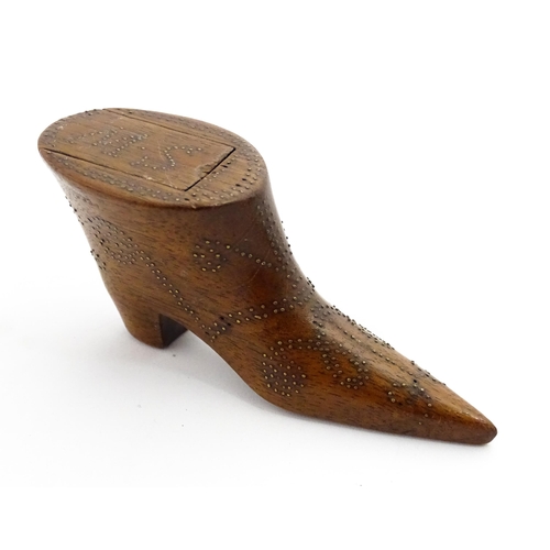 1368 - Treen : A 19thC shoe snuff box of boot form with inlaid brass studwork decoration, the sliding lid w... 