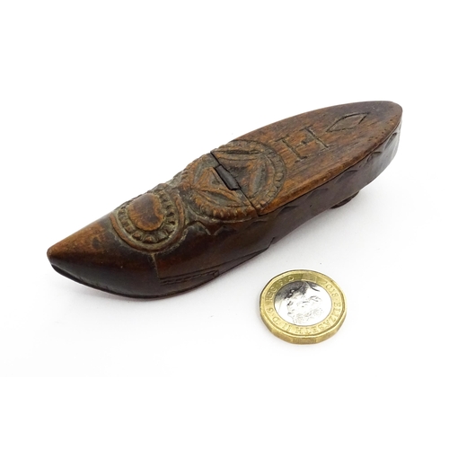 1370 - Treen : A 19thC Continental shoe snuff box with hinged lid and chip carved decoration, the lid with ... 