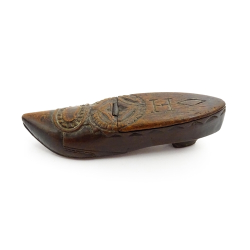 1370 - Treen : A 19thC Continental shoe snuff box with hinged lid and chip carved decoration, the lid with ... 