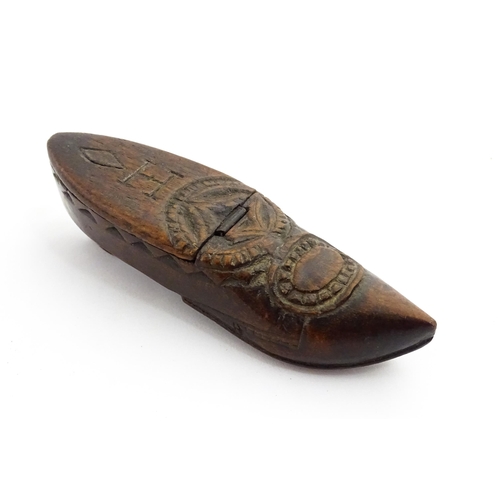 1370 - Treen : A 19thC Continental shoe snuff box with hinged lid and chip carved decoration, the lid with ... 