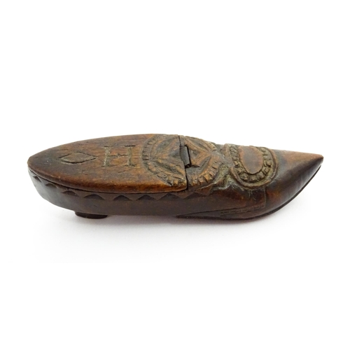 1370 - Treen : A 19thC Continental shoe snuff box with hinged lid and chip carved decoration, the lid with ... 