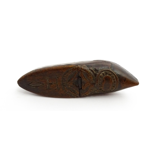 1370 - Treen : A 19thC Continental shoe snuff box with hinged lid and chip carved decoration, the lid with ... 