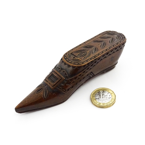 1371 - Treen : A large 19thC Continental shoe snuff box with sliding lid, and chip carved decoration with f... 