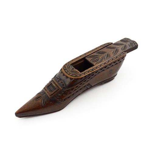 1371 - Treen : A large 19thC Continental shoe snuff box with sliding lid, and chip carved decoration with f... 