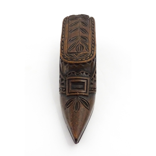 1371 - Treen : A large 19thC Continental shoe snuff box with sliding lid, and chip carved decoration with f... 