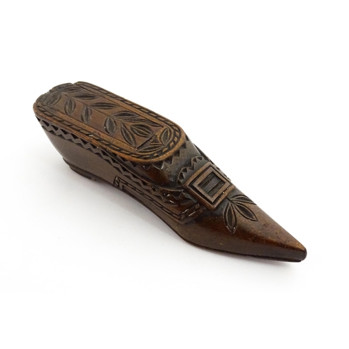 1371 - Treen : A large 19thC Continental shoe snuff box with sliding lid, and chip carved decoration with f... 