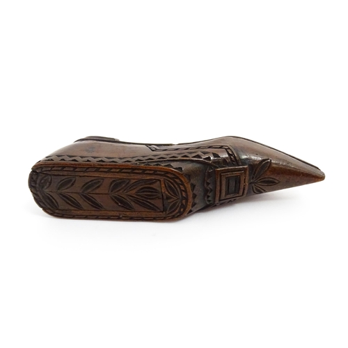 1371 - Treen : A large 19thC Continental shoe snuff box with sliding lid, and chip carved decoration with f... 