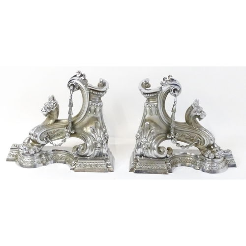 1584 - A pair of continental fire chenets, each formed as scrolls and heavily decorated with lion masks and... 