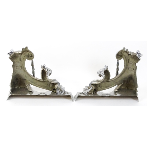 1584 - A pair of continental fire chenets, each formed as scrolls and heavily decorated with lion masks and... 