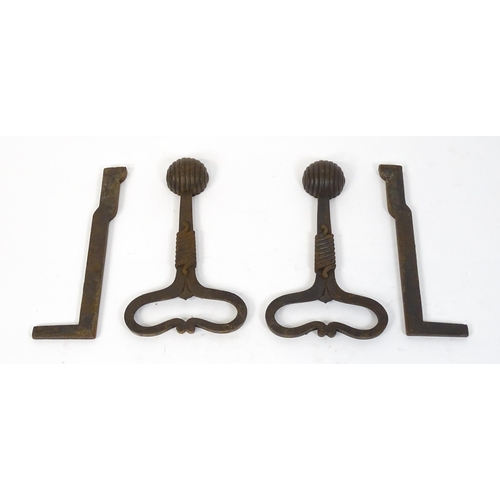 1588 - A pair of Art Nouveau cast iron andirons / firedogs, with looped bases, rope twist decoration and te... 