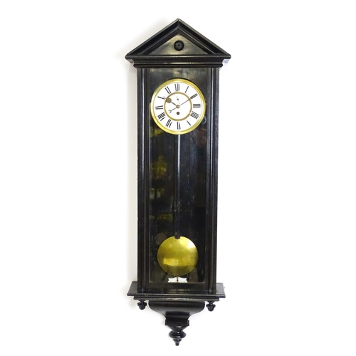 1648 - A late 19th / early 20thC ebonised Vienna wall clock with white enamel dial and Roman chapter ring. ... 