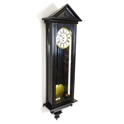 1648 - A late 19th / early 20thC ebonised Vienna wall clock with white enamel dial and Roman chapter ring. ... 