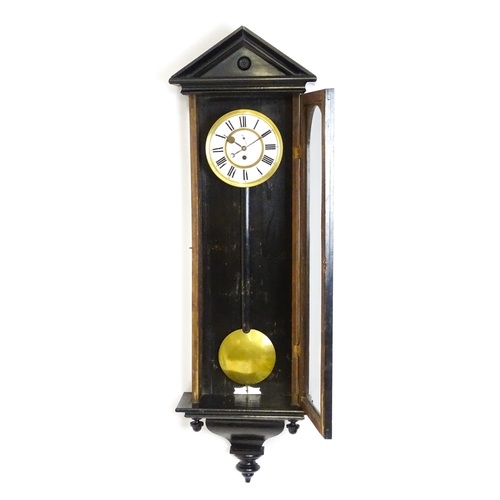 1648 - A late 19th / early 20thC ebonised Vienna wall clock with white enamel dial and Roman chapter ring. ... 