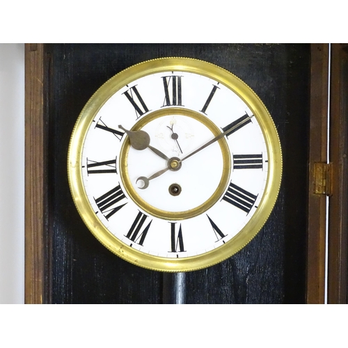 1648 - A late 19th / early 20thC ebonised Vienna wall clock with white enamel dial and Roman chapter ring. ... 