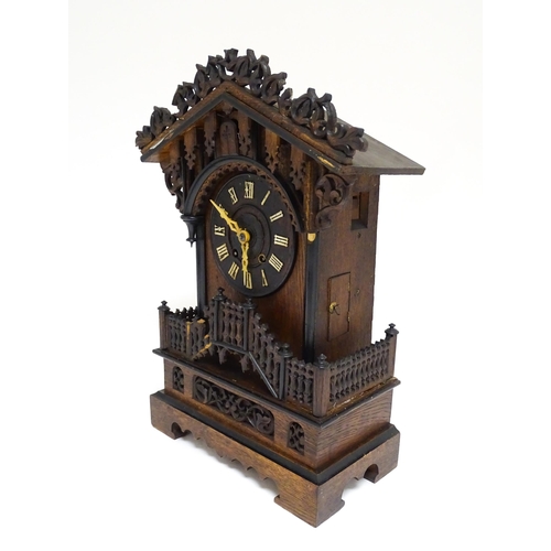 1650A - A 20thC oak cased Black Forest cuckoo clock. Approx 20 1/2