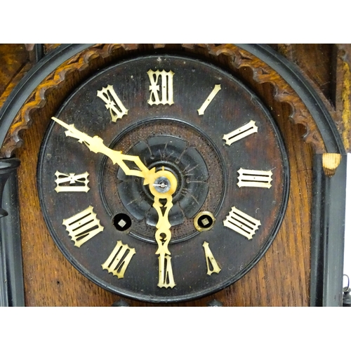 1650A - A 20thC oak cased Black Forest cuckoo clock. Approx 20 1/2