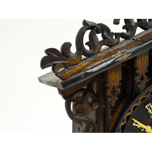 1650A - A 20thC oak cased Black Forest cuckoo clock. Approx 20 1/2