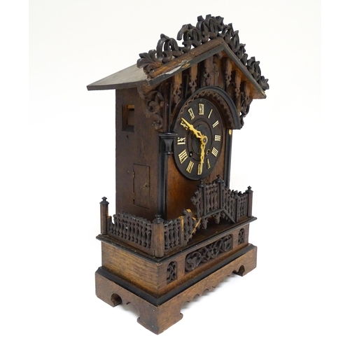 1650A - A 20thC oak cased Black Forest cuckoo clock. Approx 20 1/2