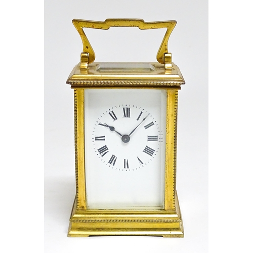 1652 - A French brass carriage clock with white enamel dial and Roman chapter ring. Approx 5 3/4