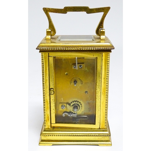 1652 - A French brass carriage clock with white enamel dial and Roman chapter ring. Approx 5 3/4