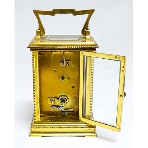 1652 - A French brass carriage clock with white enamel dial and Roman chapter ring. Approx 5 3/4