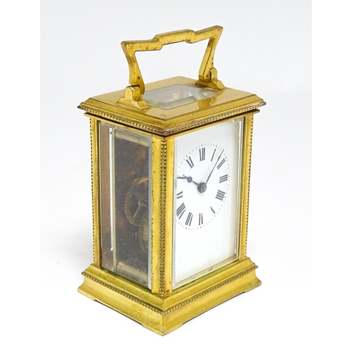 1652 - A French brass carriage clock with white enamel dial and Roman chapter ring. Approx 5 3/4