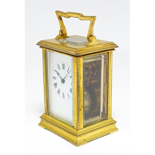 1652 - A French brass carriage clock with white enamel dial and Roman chapter ring. Approx 5 3/4