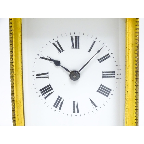 1652 - A French brass carriage clock with white enamel dial and Roman chapter ring. Approx 5 3/4