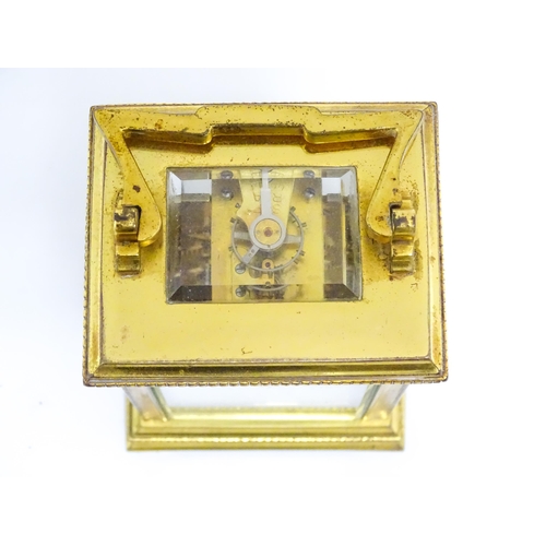 1652 - A French brass carriage clock with white enamel dial and Roman chapter ring. Approx 5 3/4