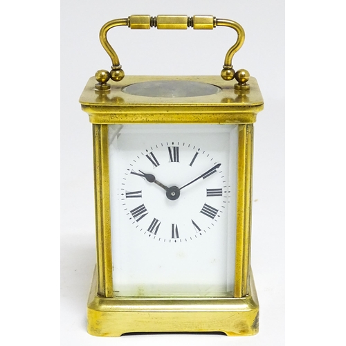 1653 - A French brass carriage clock with white enamel dial and Roman chapter ring.  The movement marked wi... 