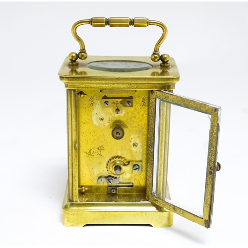 1653 - A French brass carriage clock with white enamel dial and Roman chapter ring.  The movement marked wi... 