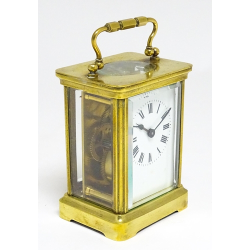 1653 - A French brass carriage clock with white enamel dial and Roman chapter ring.  The movement marked wi... 