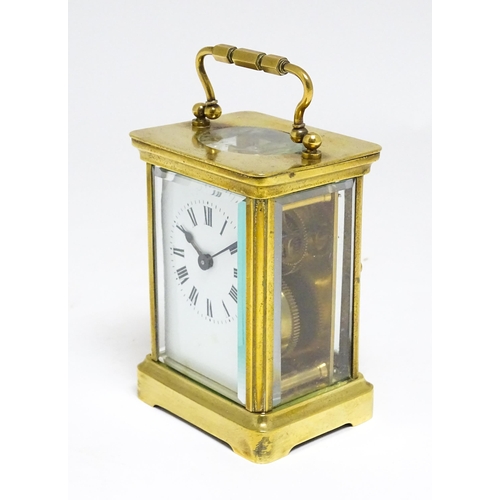 1653 - A French brass carriage clock with white enamel dial and Roman chapter ring.  The movement marked wi... 