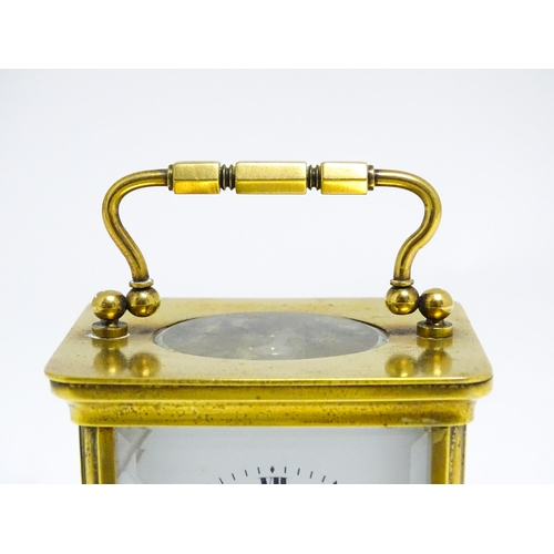 1653 - A French brass carriage clock with white enamel dial and Roman chapter ring.  The movement marked wi... 