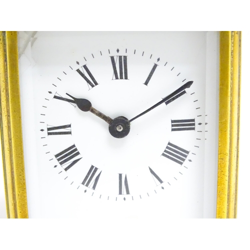 1653 - A French brass carriage clock with white enamel dial and Roman chapter ring.  The movement marked wi... 