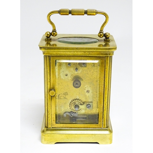 1653 - A French brass carriage clock with white enamel dial and Roman chapter ring.  The movement marked wi... 