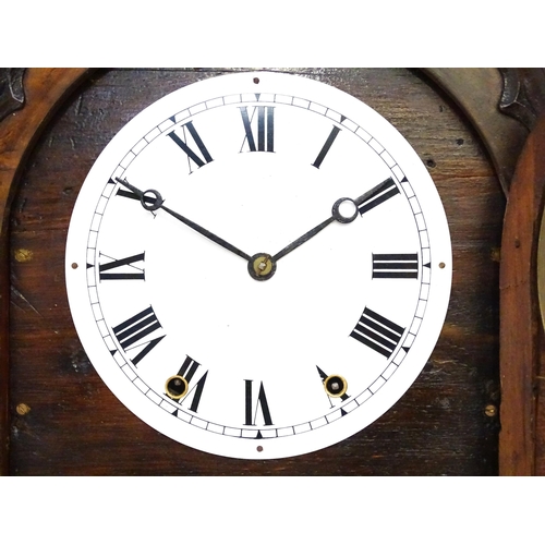 1656 - A Victorian 8-day wall clock, the walnut veneered case with twist columns surmounted by a cross form... 