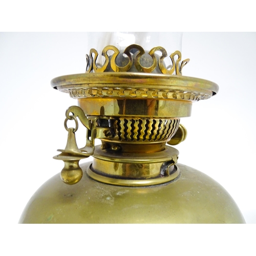 1669 - An Art Nouveau adjustable oil lamp with glass shade. Approx. 72 1/2