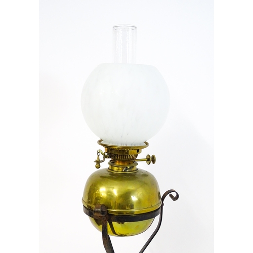 1669 - An Art Nouveau adjustable oil lamp with glass shade. Approx. 72 1/2