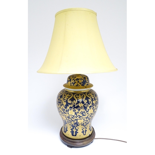 1671 - A large 20thC table lamp formed as a Chinese jar and cover, the blue ground with gilt floral and fol... 