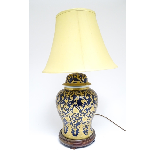 1671 - A large 20thC table lamp formed as a Chinese jar and cover, the blue ground with gilt floral and fol... 