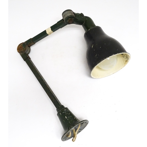 1686 - A vintage industrial green painted adjustable lamp.