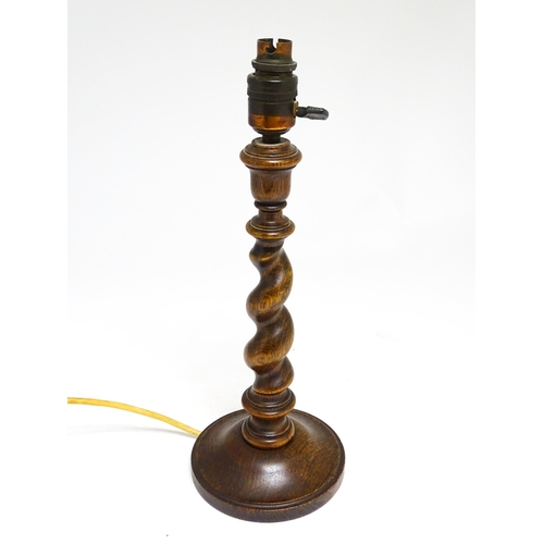 1691 - An oak barley twist table lamp with turned decoration. Approx. 15 1/2