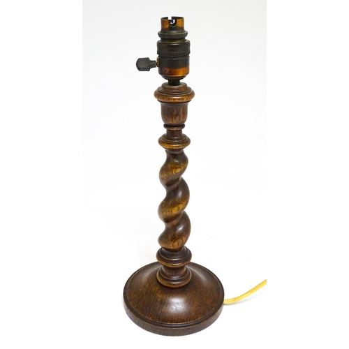 1691 - An oak barley twist table lamp with turned decoration. Approx. 15 1/2