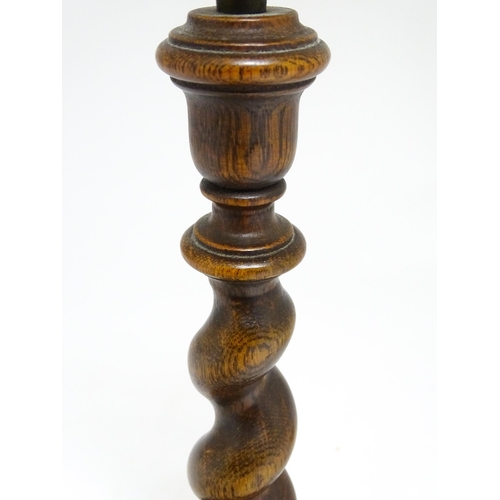 1691 - An oak barley twist table lamp with turned decoration. Approx. 15 1/2