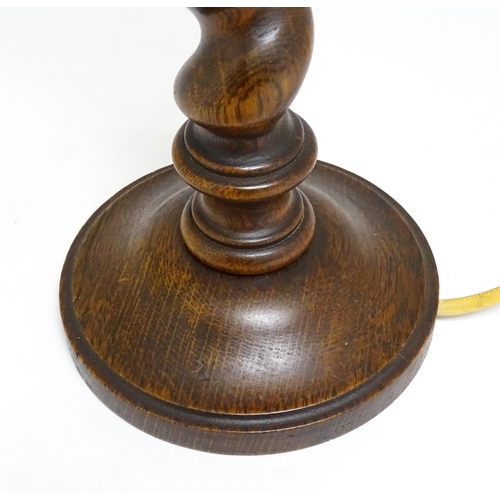 1691 - An oak barley twist table lamp with turned decoration. Approx. 15 1/2