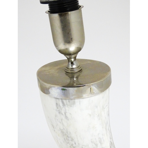 1694 - A 20thC table lamp the body of horn form, mounted on a weight silver plate base. Approx. 29