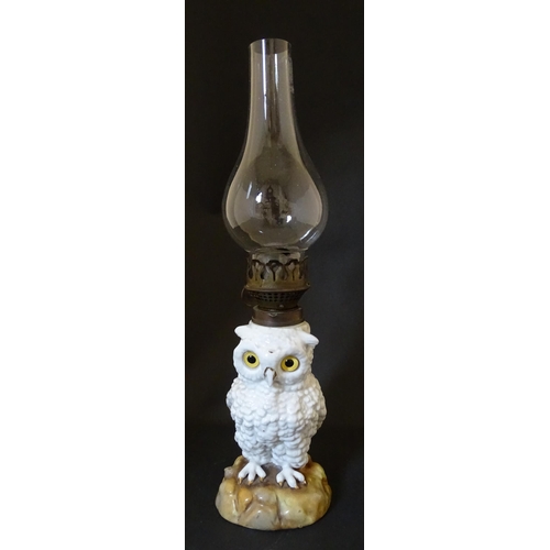 1697 - A novelty oil lamp the ceramic base formed as an owl with glass eyes. Marked under. Approx. 14 1/2