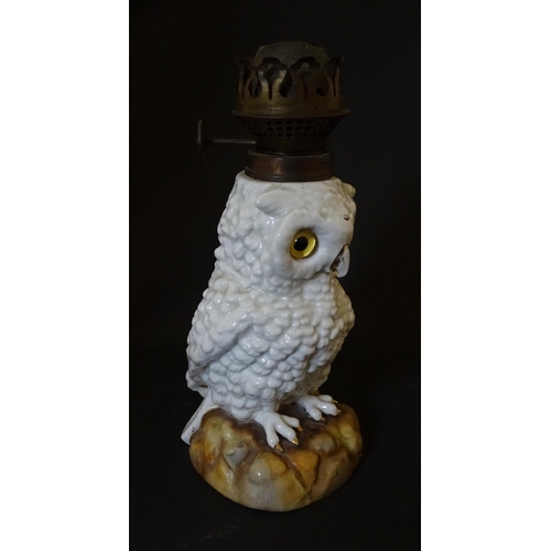 1697 - A novelty oil lamp the ceramic base formed as an owl with glass eyes. Marked under. Approx. 14 1/2